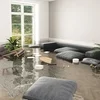 Pieces of furniture are adrift in a flooded living room