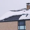 roof with snow on the shingles in the winter